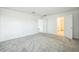 Clean bedroom featuring gray carpet and an open doorway to another room at 264 Hayley St, Winter Haven, FL 33884