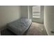 Bedroom featuring soft carpeting, a window with blinds, and a queen bed at 264 Hayley St, Winter Haven, FL 33884