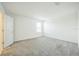 Bright bedroom with gray carpet and ample natural light from the window at 264 Hayley St, Winter Haven, FL 33884