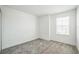 Bright bedroom with gray carpet and a large window, showcasing natural light at 264 Hayley St, Winter Haven, FL 33884