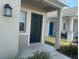 Covered front porch featuring a dark front door and modern exterior lighting at 264 Hayley St, Winter Haven, FL 33884