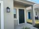 Covered front porch featuring a dark front door and modern exterior lighting at 264 Hayley St, Winter Haven, FL 33884