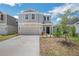 Two-story home featuring a two car garage, landscaped yard and a welcoming front entrance at 264 Hayley St, Winter Haven, FL 33884