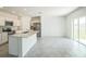 Modern kitchen with an island, stainless steel appliances, and a sliding glass door at 264 Hayley St, Winter Haven, FL 33884