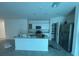 This kitchen features an island, stainless steel appliances, and ample cabinet space at 264 Hayley St, Winter Haven, FL 33884