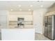 Bright kitchen featuring stainless steel appliances, an island with sink, and white cabinetry at 264 Hayley St, Winter Haven, FL 33884
