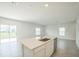 Bright kitchen features an island with stainless steel appliances and ample counter space at 264 Hayley St, Winter Haven, FL 33884