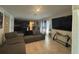 Spacious living room with tile floors, a large sectional sofa, and a modern entertainment center at 264 Hayley St, Winter Haven, FL 33884