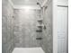 Updated tiled shower with sleek fixtures and built-in shelving at 264 Hayley St, Winter Haven, FL 33884