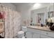 Bathroom featuring a granite countertop vanity, toilet, shower with curtain and ample space at 304 Southern Pecan Cir # 105, Winter Garden, FL 34787