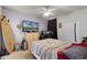 A bedroom with a surfboard, a TV screen, and a cozy bed setup at 304 Southern Pecan Cir # 105, Winter Garden, FL 34787