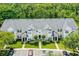 A charming townhome exterior showcasing well-manicured landscaping and ample parking spaces at 304 Southern Pecan Cir # 105, Winter Garden, FL 34787