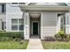 Inviting front door entrance with green door, complemented by lush green landscaping at 304 Southern Pecan Cir # 105, Winter Garden, FL 34787