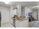 Bright kitchen with granite countertops and stainless steel dishwasher near the living area at 304 Southern Pecan Cir # 105, Winter Garden, FL 34787