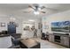 Open-concept living room showcasing modern furnishings and seamless flow into the kitchen at 304 Southern Pecan Cir # 105, Winter Garden, FL 34787