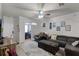 Cozy living room featuring a plush gray sectional, ceiling fan, and decorative wall art at 304 Southern Pecan Cir # 105, Winter Garden, FL 34787