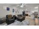 Inviting living room boasting comfortable seating, a ceiling fan, and a view of the kitchen at 304 Southern Pecan Cir # 105, Winter Garden, FL 34787