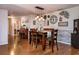 Dining room with hardwood floors, stylish light fixture, and decorative wall art at 30546 Lipizzan Ter, Mount Dora, FL 32757