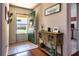 Inviting foyer with tile flooring, painted green door and a rustic wood console table at 30546 Lipizzan Ter, Mount Dora, FL 32757