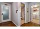 Hallway view featuring doors to the bathroom and laundry room and hardwood flooring at 30546 Lipizzan Ter, Mount Dora, FL 32757