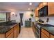 Well-equipped kitchen featuring granite countertops, tile flooring, wooden cabinets and stainless steel appliances at 30546 Lipizzan Ter, Mount Dora, FL 32757