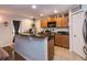 Modern kitchen with granite countertops, wooden cabinets and stainless steel appliances at 30546 Lipizzan Ter, Mount Dora, FL 32757