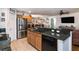 Open kitchen featuring granite counters, an island with a sink, and stainless steel appliances at 30546 Lipizzan Ter, Mount Dora, FL 32757