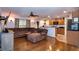 Comfortable living room featuring hardwood floors, sectional sofa, and bar top access to kitchen at 30546 Lipizzan Ter, Mount Dora, FL 32757