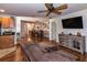 Spacious living room with hardwood floors, a ceiling fan and direct access to the dining area at 30546 Lipizzan Ter, Mount Dora, FL 32757