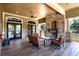 Covered outdoor patio with seating and a beautiful stone fireplace at 30546 Lipizzan Ter, Mount Dora, FL 32757