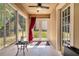 Bright sunroom with lots of windows and ceiling fan at 30546 Lipizzan Ter, Mount Dora, FL 32757