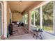 Bright sunroom with lots of windows, neutral decor, and ceiling fan at 30546 Lipizzan Ter, Mount Dora, FL 32757