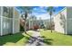 Charming courtyard view featuring lush landscaping and inviting walkways between attractive apartment buildings at 316 Scottsdale Sq # 316, Winter Park, FL 32792