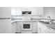 Functional kitchen featuring ample white cabinetry and essential appliances for efficient cooking at 316 Scottsdale Sq # 316, Winter Park, FL 32792