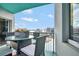 Cozy balcony featuring a glass table, wicker chairs, and a picturesque city view at 322 E Central Blvd # 1909, Orlando, FL 32801