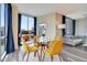 Dining area with glass table, seating for four, and expansive windows showcasing city views with curtains at 322 E Central Blvd # 1909, Orlando, FL 32801