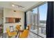 Dining area with floor to ceiling windows, a modern table with seating for four, and great city views at 322 E Central Blvd # 1909, Orlando, FL 32801