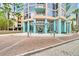 Elegant building entrance with teal pillars and a glass awning over a brick paved drive at 322 E Central Blvd # 1909, Orlando, FL 32801