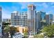 Stunning exterior view of a modern high-rise residential building with curved design and a glass facade at 322 E Central Blvd # 1909, Orlando, FL 32801