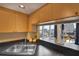Updated kitchen features stainless steel sink and dark counters with a breakfast bar with city views at 322 E Central Blvd # 1909, Orlando, FL 32801