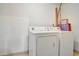 Simple laundry room includes a standard washer and dryer in a clean, neutral space at 322 E Central Blvd # 1909, Orlando, FL 32801