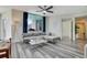 Comfortable living room features wood-look flooring, floor to ceiling windows, and neutral furnishings at 322 E Central Blvd # 1909, Orlando, FL 32801