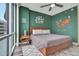Stylish main bedroom with elegant green wall, wood bed frame, and cityscape views at 322 E Central Blvd # 1909, Orlando, FL 32801