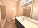 Well-lit bathroom featuring a vanity with a large mirror and a tiled shower/tub combo at 3506 Creswick Cir, Orlando, FL 32829