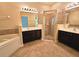 Bathroom with dual vanities, tiled shower, and soaking tub at 3506 Creswick Cir, Orlando, FL 32829
