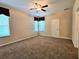 Bedroom with ceiling fan, plush carpet, and natural light at 3506 Creswick Cir, Orlando, FL 32829