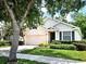 Charming single-story home featuring a two-car garage, manicured lawn, and lush tree at 3506 Creswick Cir, Orlando, FL 32829