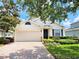 Charming single-story home featuring a two-car garage, manicured lawn, and well-maintained landscaping at 3506 Creswick Cir, Orlando, FL 32829