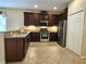 Well-lit kitchen boasts granite countertops, stainless appliances, and stylish dark wood cabinetry at 3506 Creswick Cir, Orlando, FL 32829