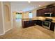 Open kitchen view with granite countertops, stainless appliances, and adjacent living area at 3506 Creswick Cir, Orlando, FL 32829